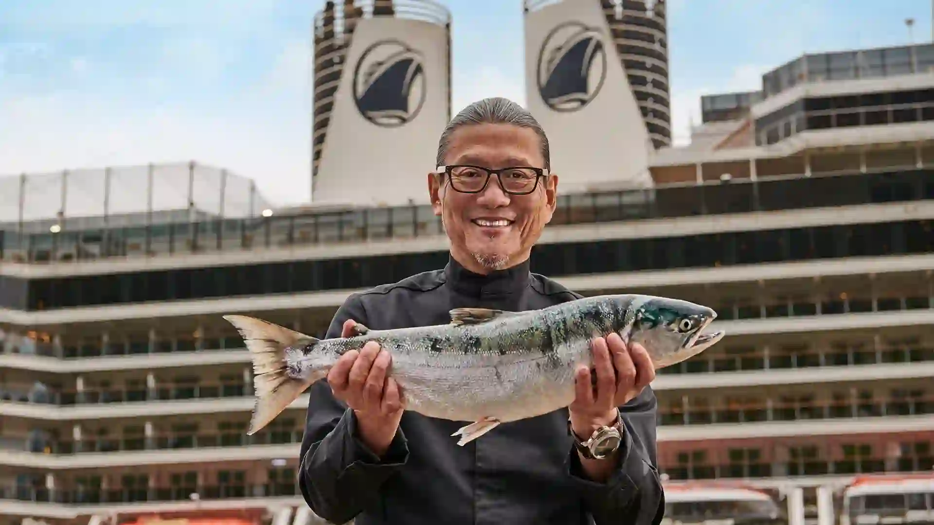 View of Chef Morimoto, celebrity chef and fresh fish ambassador, in front of Holland America Line cruise ship.